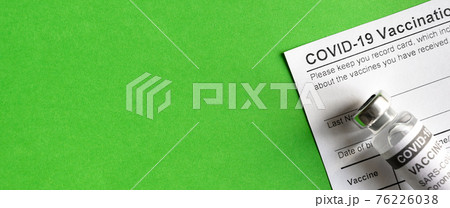 COVID-19 Vaccination Record Card on green background COVID-19 Vaccination Record Card on green background 76226038