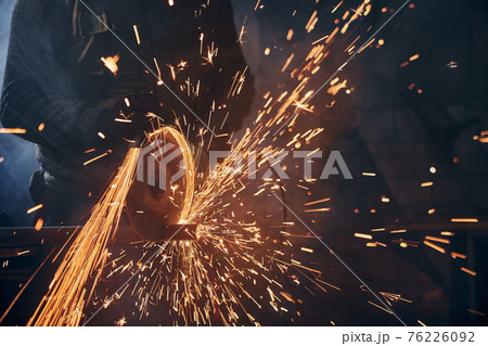 Process polishing or welding metal in factory. 76226092