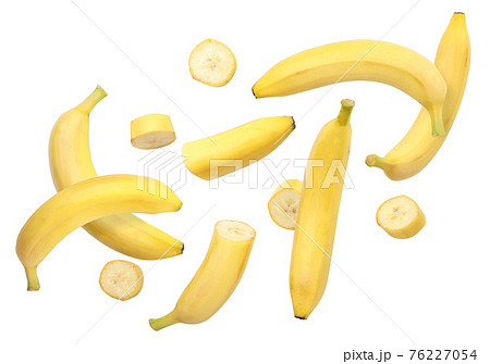 Whole bananas and slices are flying on a white background. Isolated Whole bananas and slices are flying on a white background. Isolated 76227054