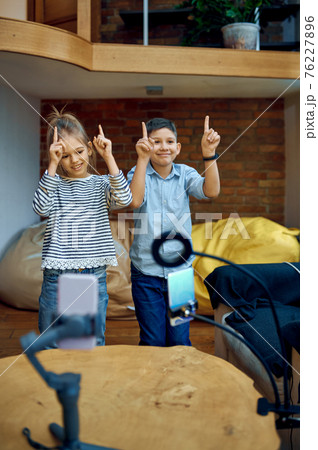 Cheerful children bloggers dance on camera Cheerful children bloggers dance on camera 76227896