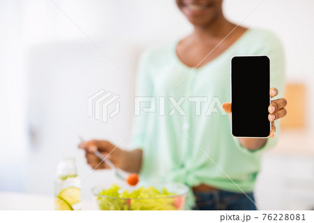 Unrecognizable African Female Showing Phone Screen Cooking In Kitchen, Cropped 76228081