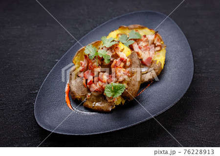 Baked whole smashed grilled potatoes with bacon Baked whole smashed grilled potatoes with bacon 76228913