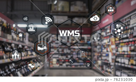 Inscription WMS on blurred warehouse background. Werehouse Management System 76231030