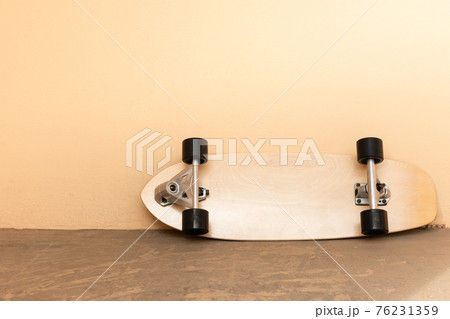 a surf skate or skateboard on dirty floor and concrete wall in. vintage tone. sport and recreation concept a surf skate or skateboard on dirty floor and concrete wall in. vintage tone. sport and recreation concept 76231359