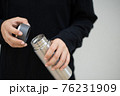 Female athlete opening the steel water bottle 76231909