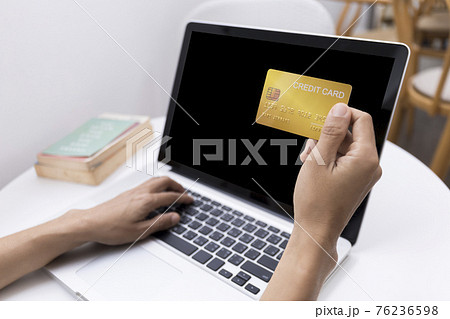 Young woman holding credit card and using laptop computer. Women working at home. Online shopping, e-commerce, internet banking, spending money, working from home concept. Technology shopping online Young woman holding credit card and using laptop computer. Women working at home. Online shopping, e-commerce, internet banking, spending money, working from home concept. Technology shopping online 76236598