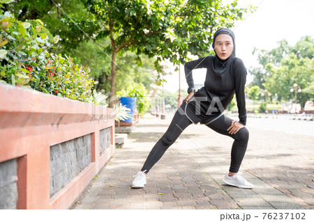 muslim asian woman strecth her leg during sport time outdoor muslim asian woman strecth her leg during sport time outdoor 76237102