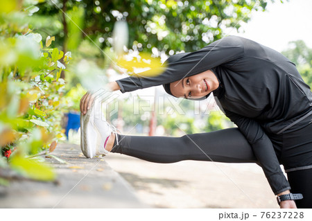 muslim asian woman strecth her leg during sport time outdoor muslim asian woman strecth her leg during sport time outdoor 76237228
