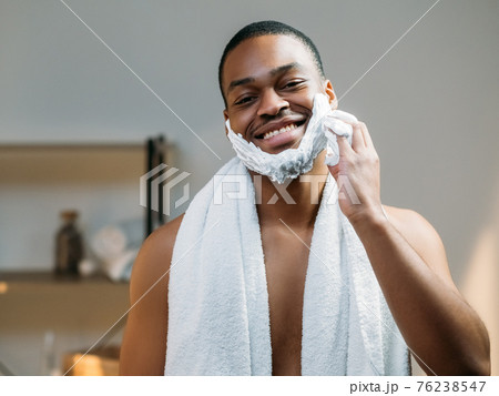 male facial care african man applying shaving foam male facial care african man applying shaving foam 76238547