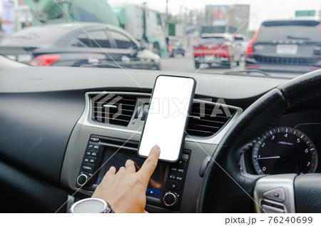 Mobile phone on the car air vent.Blank with white screen.Mock up smart phone in car. Mobile phone on the car air vent.Blank with white screen.Mock up smart phone in car. 76240699