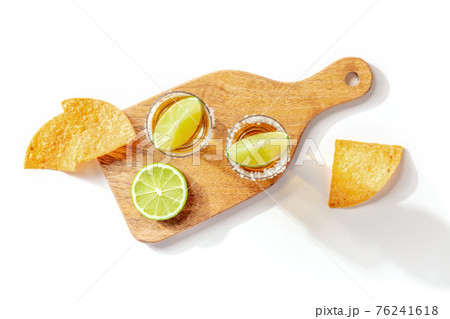 Tequila shots with limes and nachos, top shot 76241618