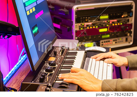 male composer, producer, arranger, song writer, musician hands arranging music on computer in home studio. music production concept male composer, producer, arranger, song writer, musician hands arranging music on computer in home studio. music production concept 76242825