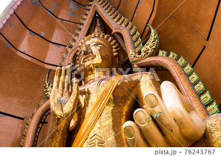 Silver chrysanthemum symbol and gold leaf In the palm of the Buddha statue 76243767