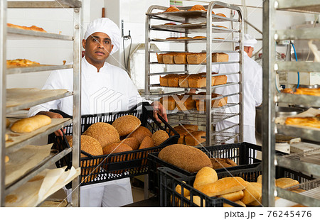 Male baker with box of bread at bakery Male baker with box of bread at bakery 76245476