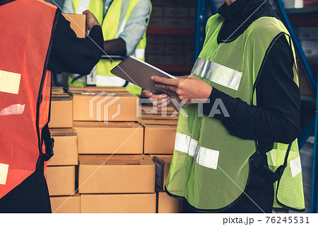 Warehouse worker working together in the storehouse Warehouse worker working together in the storehouse 76245531