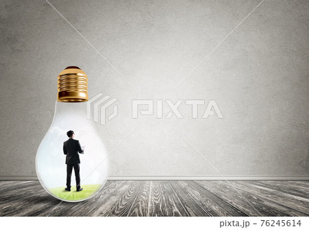 Businessman trapped in bulb 76245614