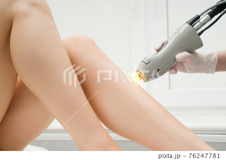 The procedure for removing hair on the body of a woman in a cosmetology clinic. Laser hair removal. The procedure for removing hair on the body of a woman in a cosmetology clinic. Laser hair removal. 76247781