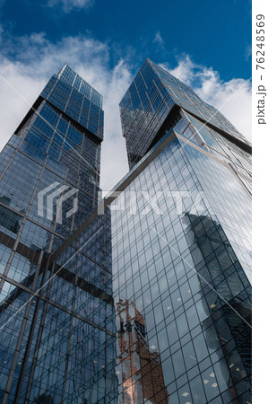 Modern corporate buildings against blue cloud sky. 76248569