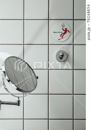 Luxury bathroom interior with tub, shower shelve and walk in shower. White and black tiles 76248654