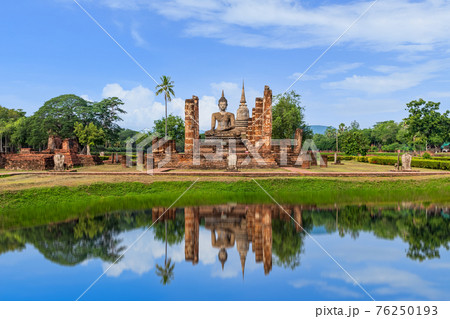 Buddha statue and Pagoda in ruined monastery complex at Wat Mahathat temple with reflection, Sukhothai Historical Park, Thailand Buddha statue and Pagoda in ruined monastery complex at Wat Mahathat temple with reflection, Sukhothai Historical Park, Thailand 76250193