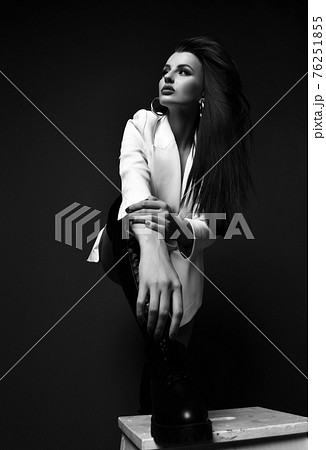 Black and white. Arrogant rich tall woman in white Black and white. Arrogant rich tall woman in white 76251855