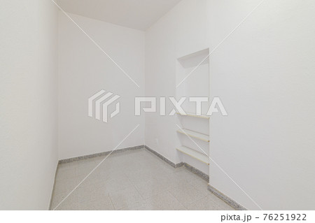 Empty small room with white walls and built-in niche for shelves in an old flat before renovation. Empty small room with white walls and built-in niche for shelves in an old flat before renovation. 76251922