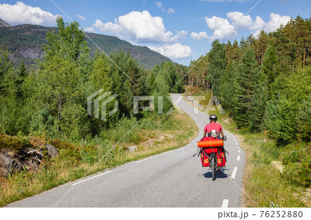 Traveling cyclist on cycle route in Southern Norway 76252880