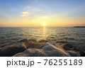 Sunset on the rocky shore of a tropical 76255189