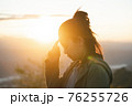 Travel woman enjoy sunset. Close up of travel girl outdoors.. 76255726