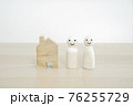 Happy family and New home concept. Family wooden peg doll on wood table. 76255729