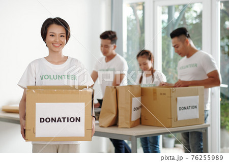 Woman working at donation center 76255989