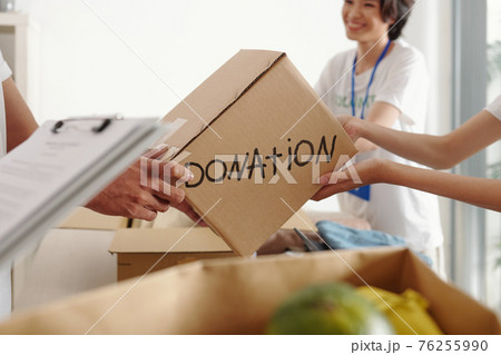 Man donating box of groceries 76255990
