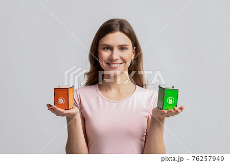 Smiling Woman Holding Small Toy Recycle Bins For Different Type Of Waste Smiling Woman Holding Small Toy Recycle Bins For Different Type Of Waste 76257949