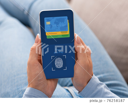 Woman paying for goods and services with Touch ID 76258187