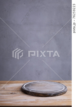 Pizza or bread cutting board and scattered wheat flour powder for homemade baking on wooden table Pizza or bread cutting board and scattered wheat flour powder for homemade baking on wooden table 76259223