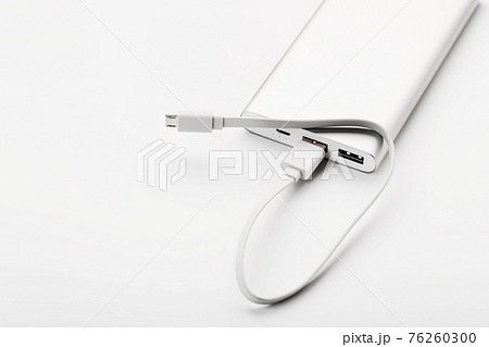 Power bank for charging mobile devices and gadgets on a white background Power bank for charging mobile devices and gadgets on a white background 76260300