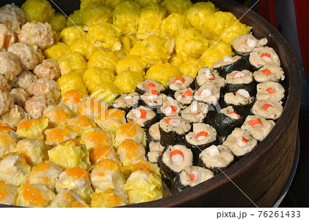 Dim Sum with miscilinous taste in wooden steam cooker. Dim Sum is one of the famous Chinese food. It is cooked by steamed with a high temperature.  76261433
