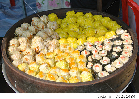 Dim Sum with miscilinous taste in wooden steam cooker. Dim Sum is one of the famous Chinese food. It is cooked by steamed with a high temperature.  76261434