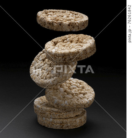 Falling puffed rice bread on black background 76261842