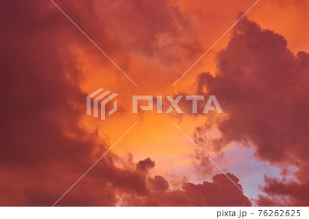Incredible red sunset clouds against the blue sky Incredible red sunset clouds against the blue sky 76262625