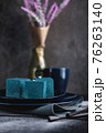 Blue cake filled with orange and tangerine in the shape of a cube. Rustic style. 76263140