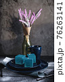 Blue cake filled with orange and tangerine in the shape of a cube. Rustic style. 76263141