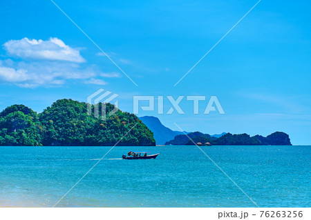 View from the beach to the rocks in the ocean away from the coast. Natural landscape of a tropical beach 76263256
