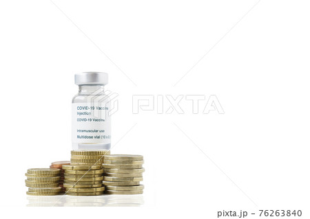 Coronavirus vaccine vial on top of a pile of coins on white background Coronavirus vaccine vial on top of a pile of coins on white background 76263840
