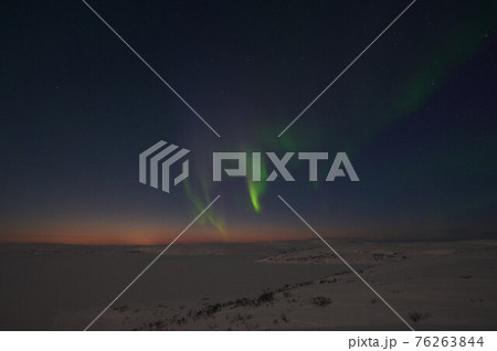 northern light on the silent field before sun rise. 76263844