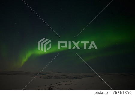 northern light on the silent field before sun rise. 76263850