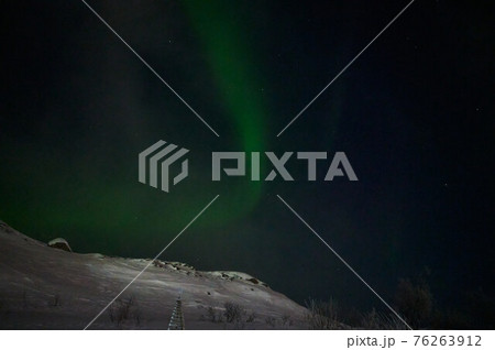 northern light on the silent field before sun rise. 76263912