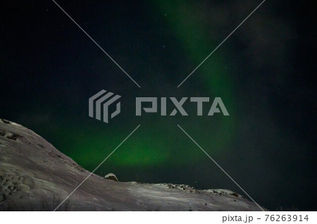 northern light on the silent field before sun rise. northern light on the silent field before sun rise. 76263914