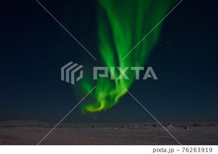 northern light on the silent field before sun rise. 76263919
