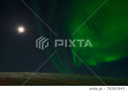northern light on the silent field before sun rise. northern light on the silent field before sun rise. 76263943